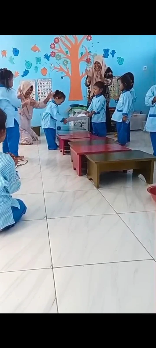 Kegiatan membawa bola menggunakan kertas . 